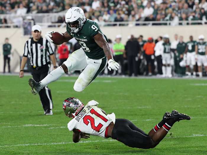 Kenneth Walker hurdles a Western Kentucky defender